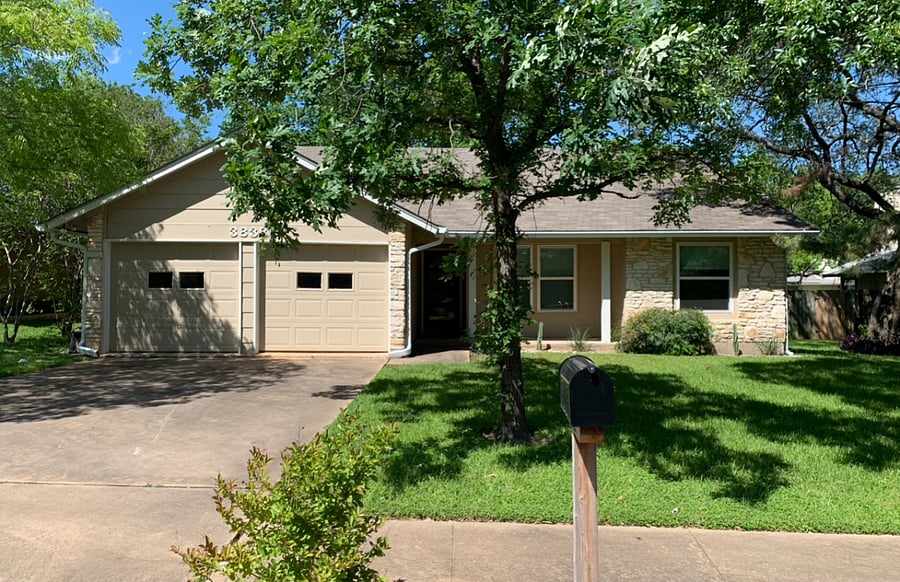 House is a beautiful ranch home with lots of trees.