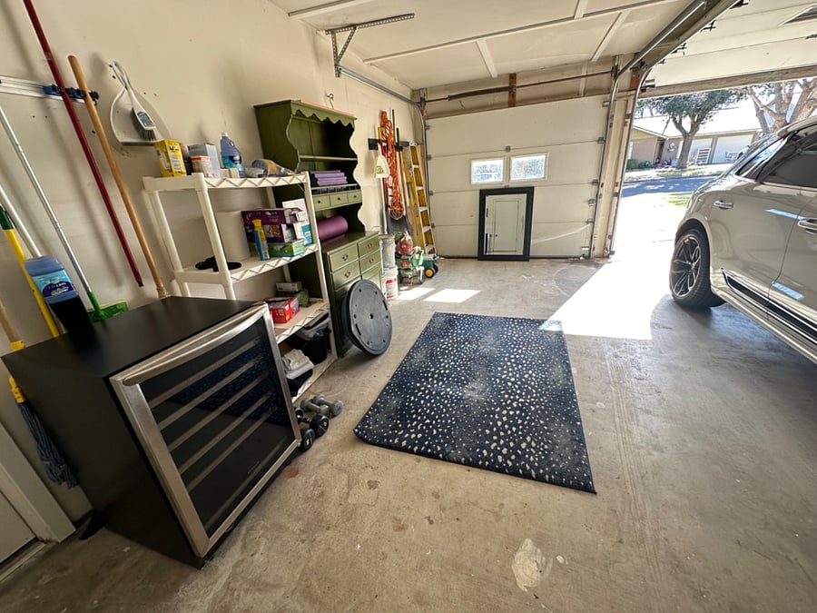 Garage has a wine fridge and some workout equipment. Garage is two car technically but only one side opens.