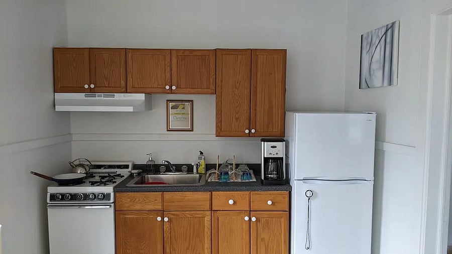 Kitchen with small stove and fridge.