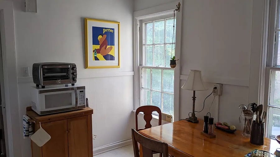 Kitchen sitting area with microwave and toaster oven.