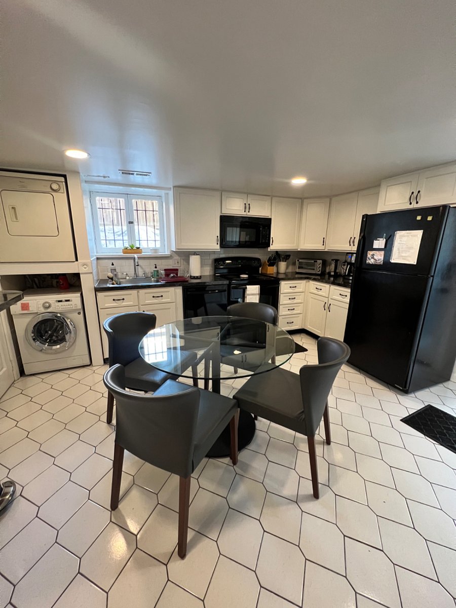 Full kitchen, with a large fridge, electric stove, oven, microwave, and ample pots, pans, plates, etc.