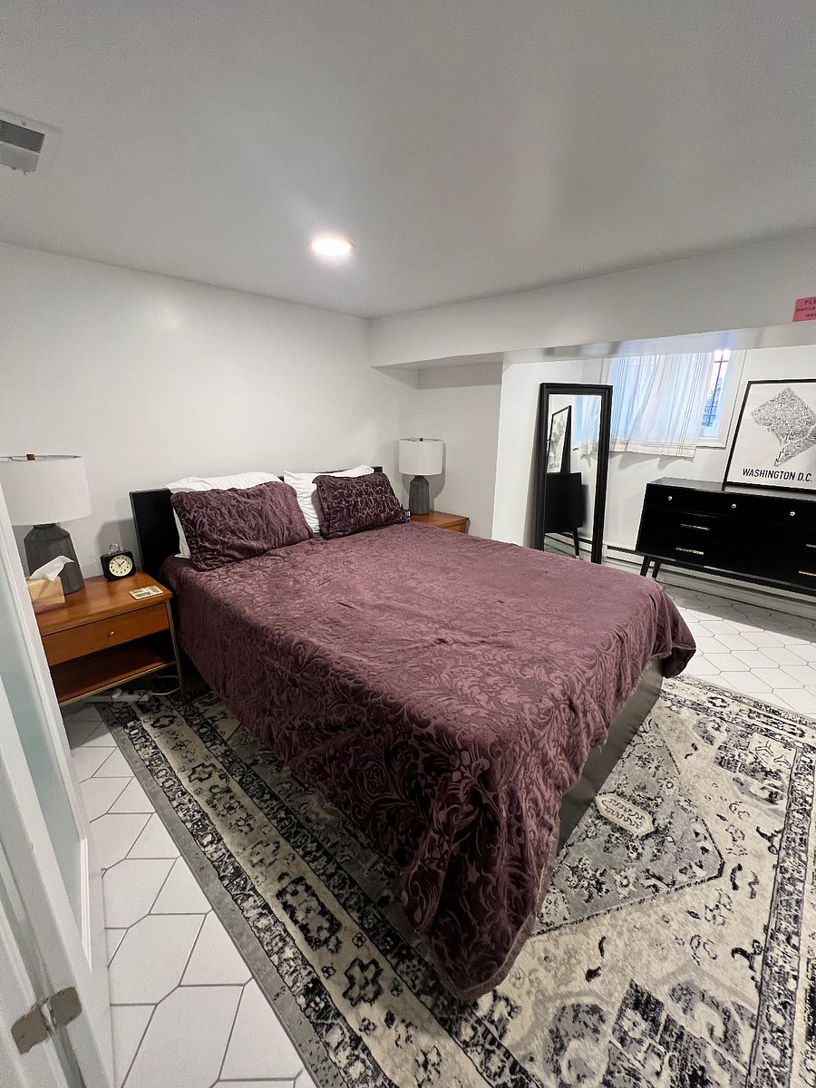 Bedroom with queen bed, dresser, and closet. Extra linens are provided.