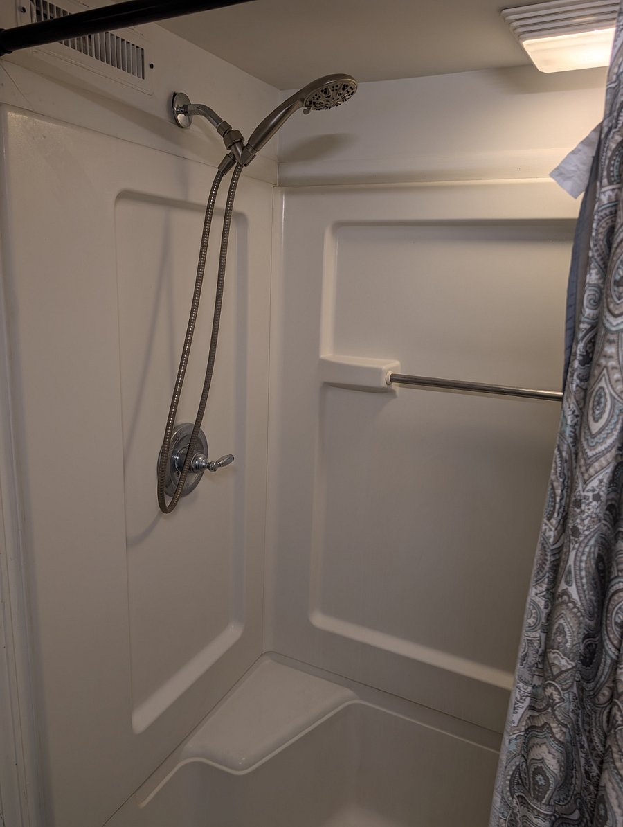 Standing shower with removable shower head