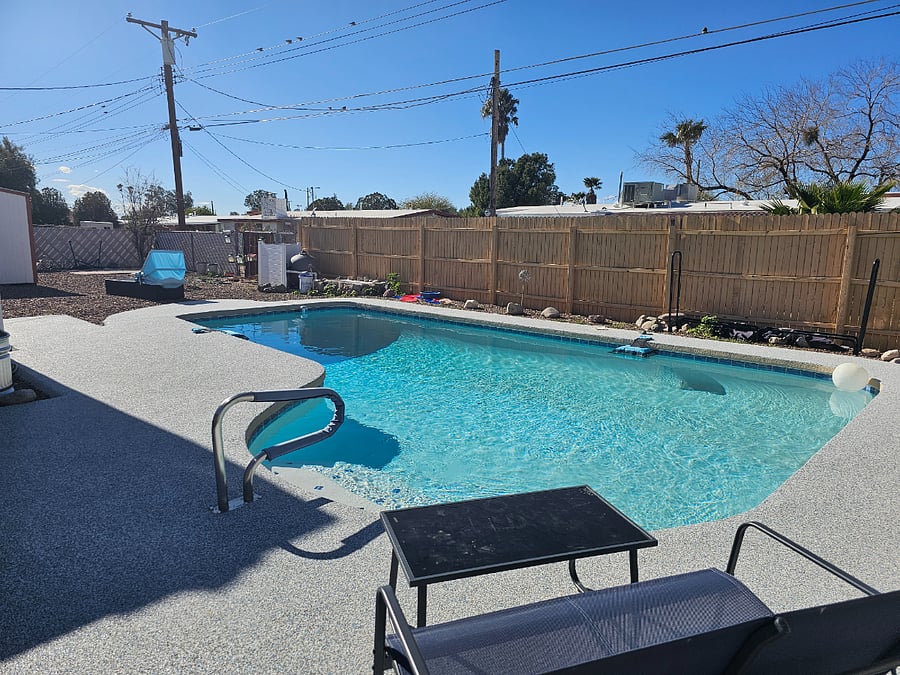 Pool with stairs and safety handrail.