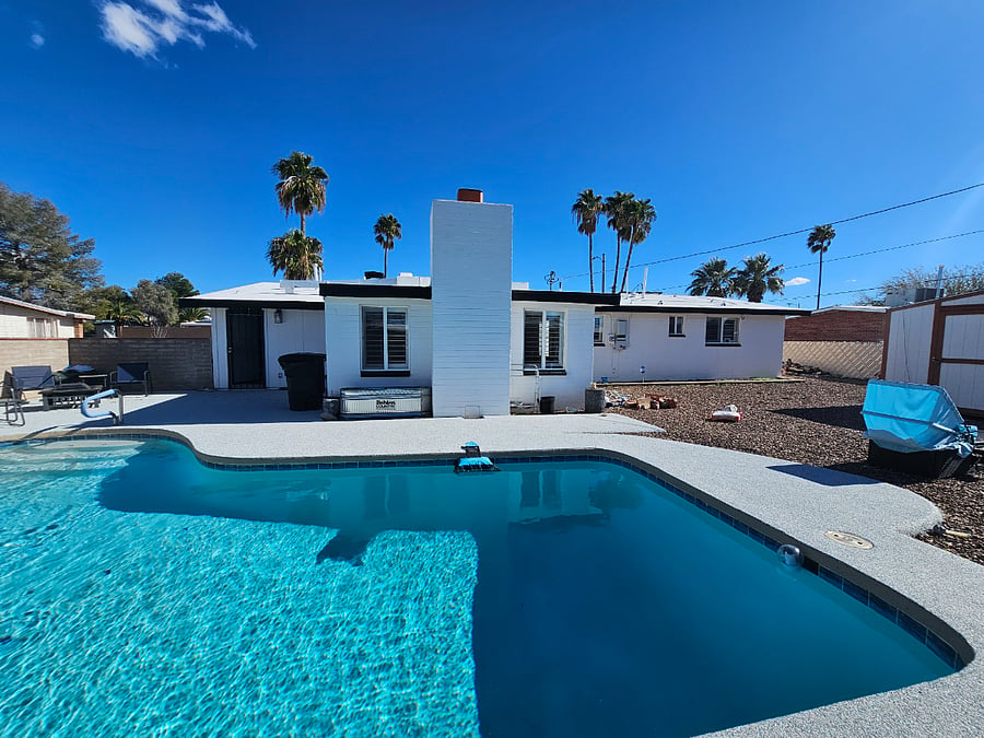 Pool with back view of house