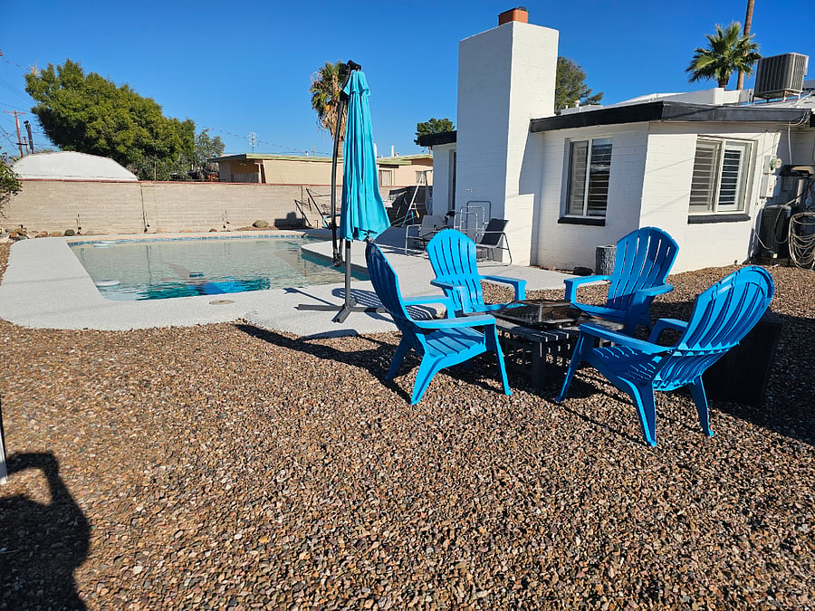 Fire pit, solar umbrella with lights, and chairs