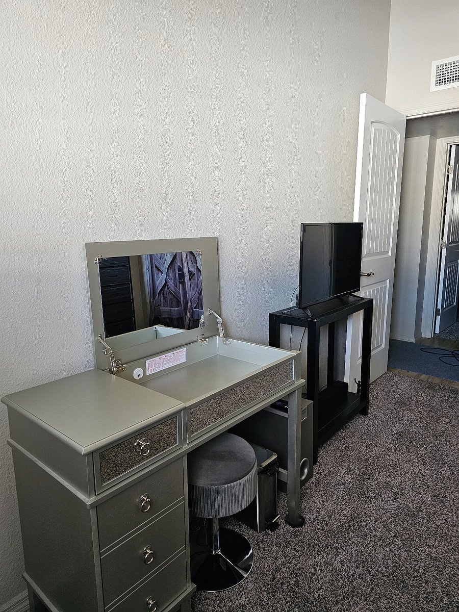 Master bedroom vanity/desk with storage chair. Smart TV