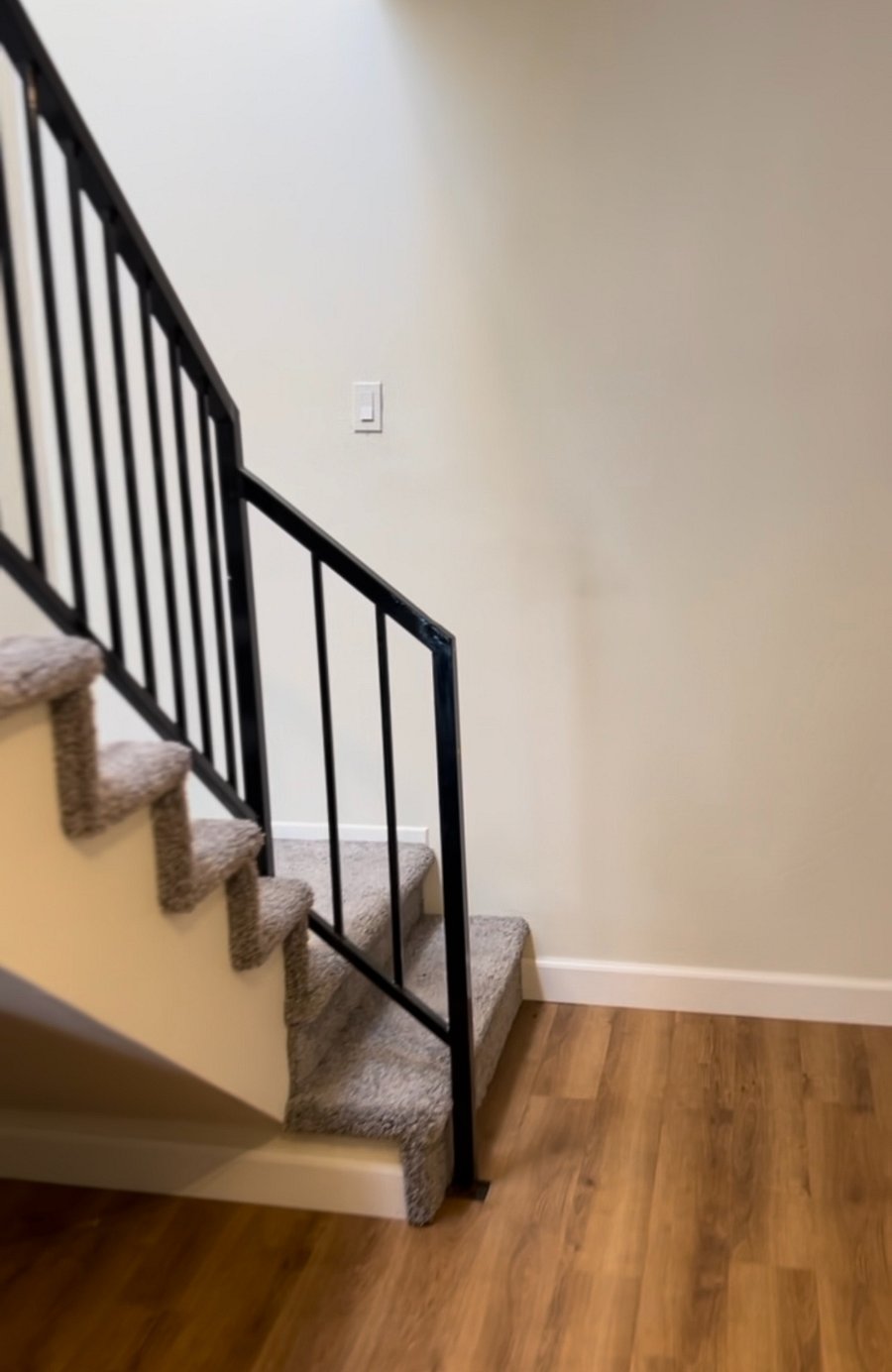 Stairs leading to large bedroom and bathroom with walk-in shower.