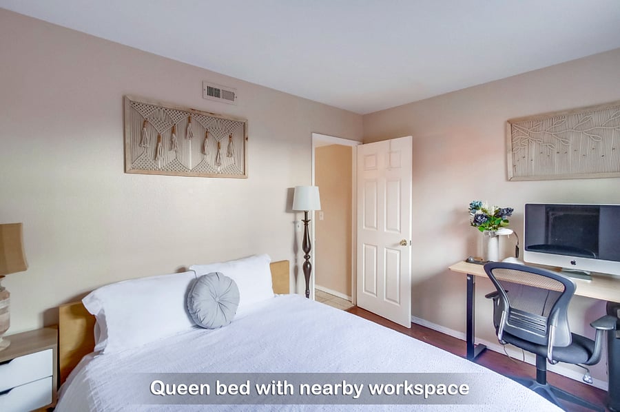 Here's comfy queen bed in Bedroom 3 with a nearby workspace to catch up on work