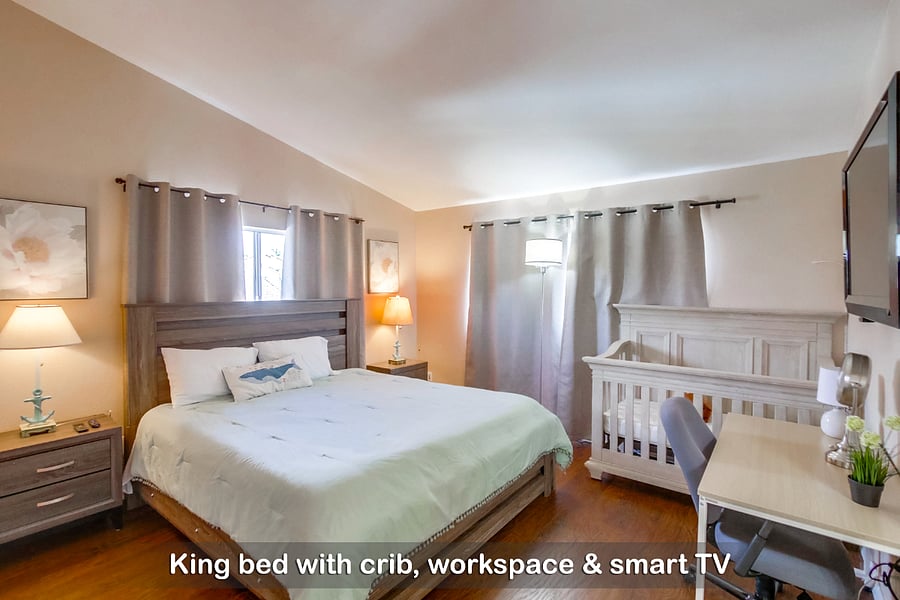 Unwind and recharge in this cloud-like king bed, with a crib for your little ones
