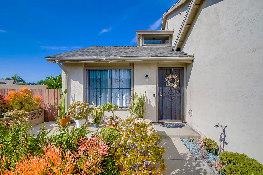 A vibrant front yard welcomes you to this luxurious, modern home