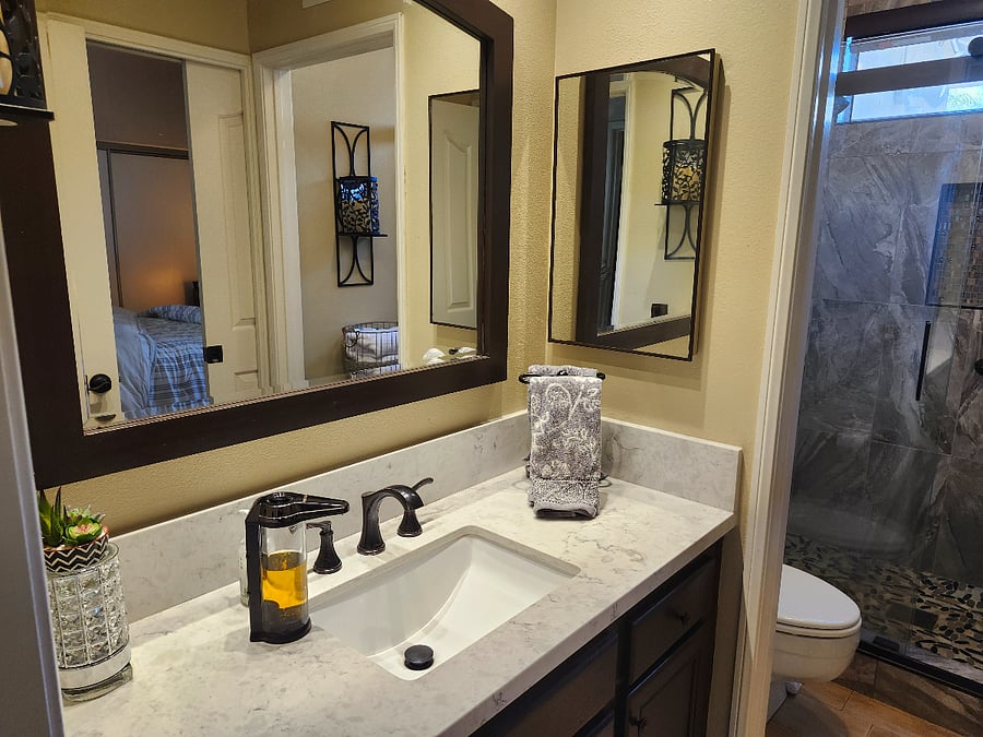 Attached bathroom off bedroom, with sliding door.