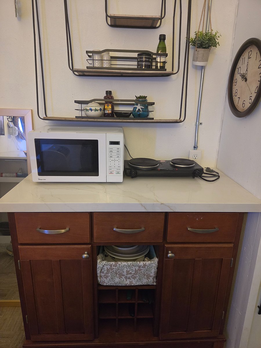 Kitchenette with quartz counters and appliances.