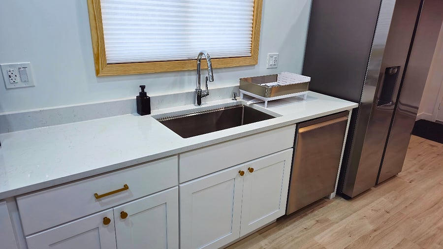 A full-size 33" Delta basin sink with a sleek pull-down Hansgrohe faucet, garbage disposal, and dish drying rack. Plus, a top-tier, ultra-quiet Samsung dishwasher with a very quiet sanitize mode and a 60-minute express wash. Kitchen towels included.