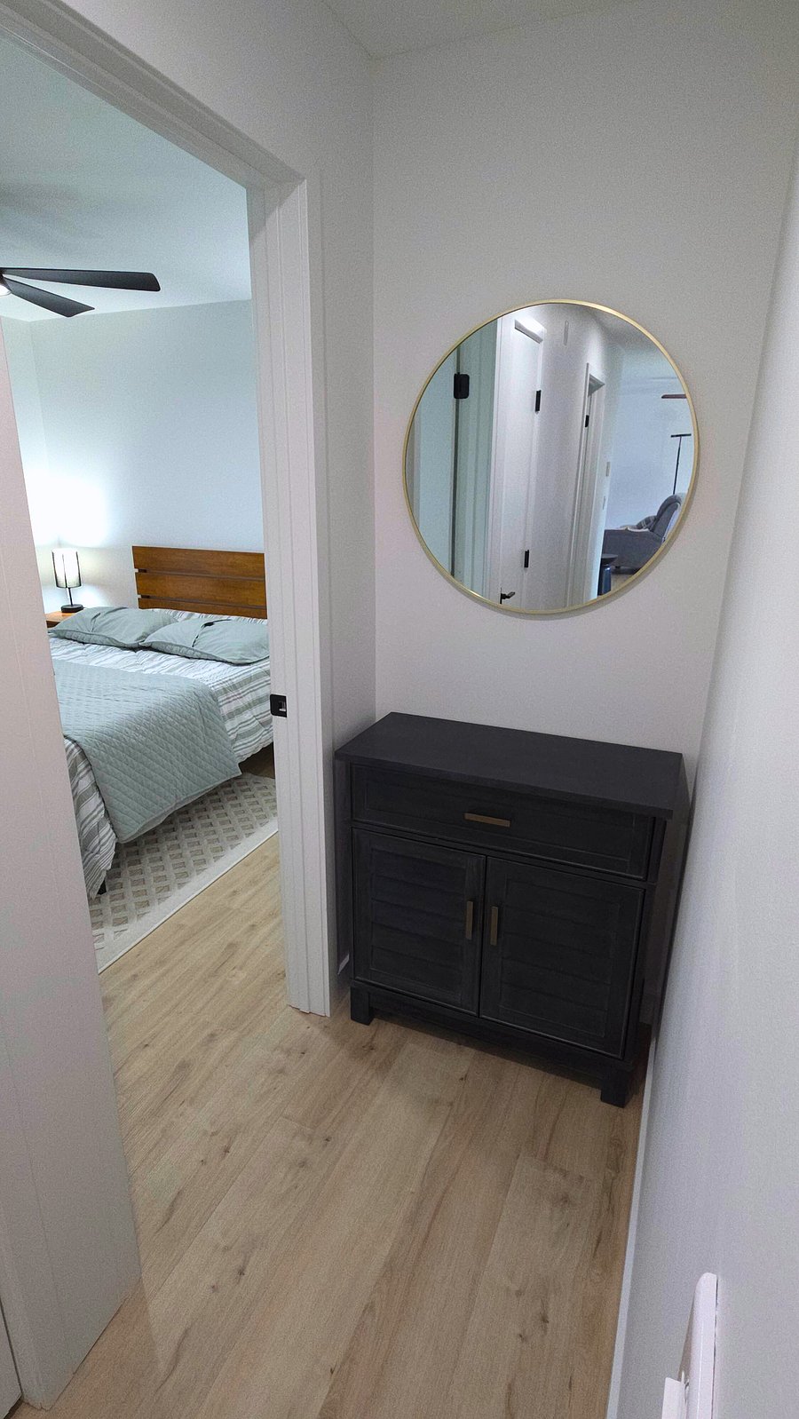 Entrance to secondary bedroom. Hallway vanity and mirror.