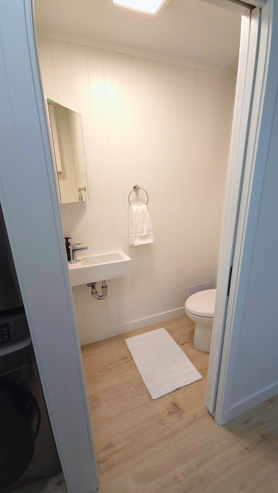 Half Bathroom. High-end chrome fixtures and hardware. Medicine cabinet.
