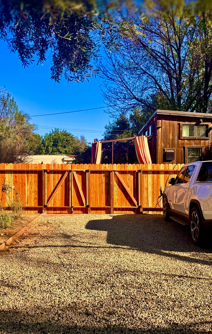 New Privacy Fence between private, gated, off road parking and Tiny House.