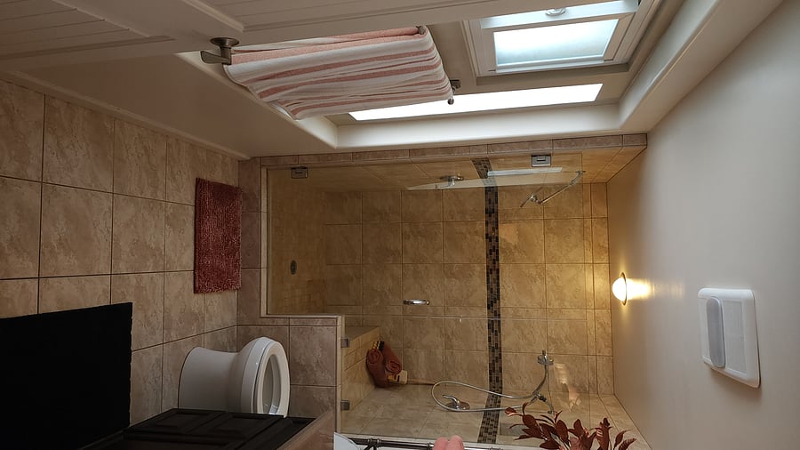 Primary shower with 2 shower heads and bench