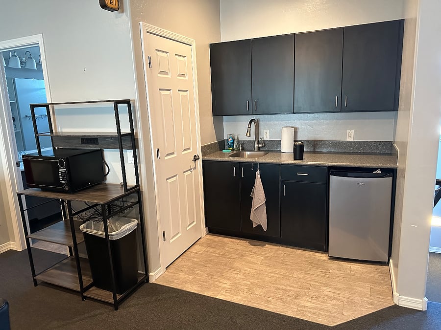 Kitchenette with microwave, cooktop, coffee maker, mini-fridge, sink, plates/cups/silverware, tons of storage and large pantry.