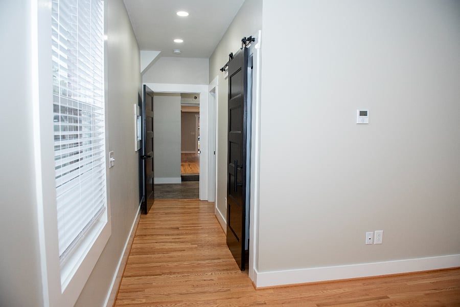 Inside the primary suite, viewing walk-in closet, bathroom, and mudroom