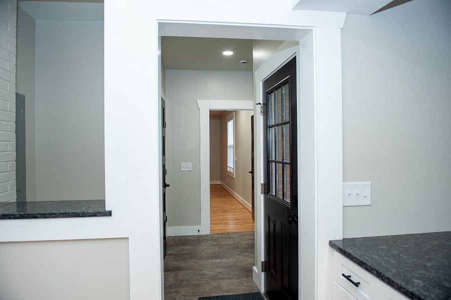 View from kitchen into the mudroom and primary suite entrance