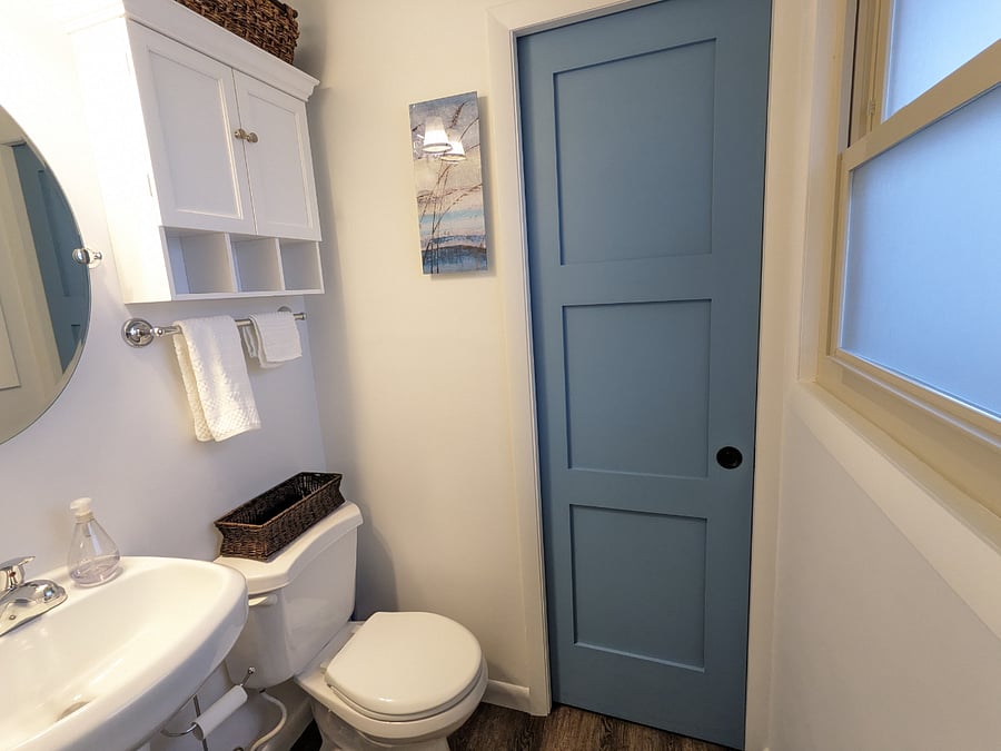 Half bath off of main bedroom. Pocket door leads to main bathroom