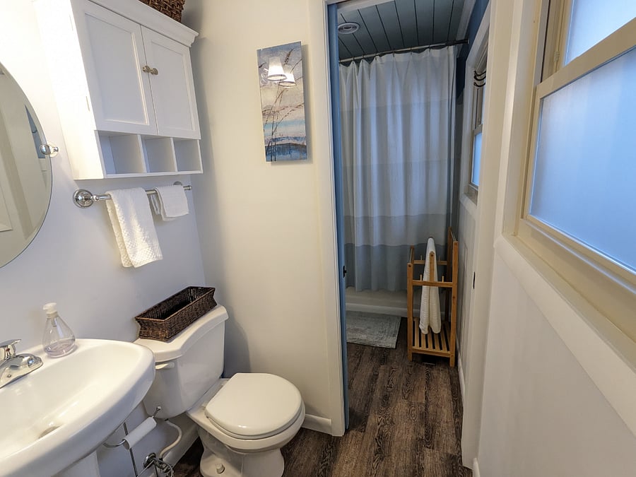 Half bathroom open pocket door leading to the main bathroom