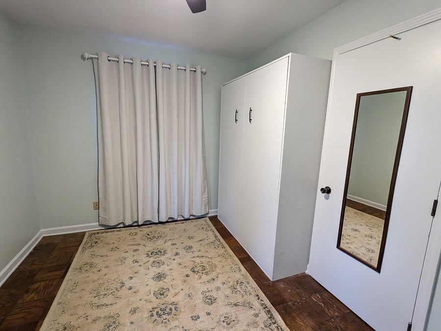 Murphy bed in the closed position next to the closet in the second bedroom