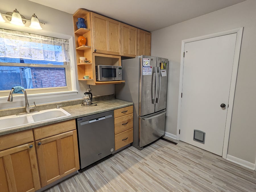 Dishwasher, microwave, large double sink, freezer on the bottom refrigerator (range not pictured)