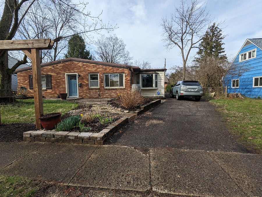 Driveway extends all the way past the house and widens in the back.