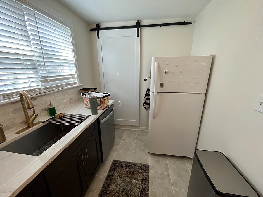 Kitchen facing the fridge and large pantry.