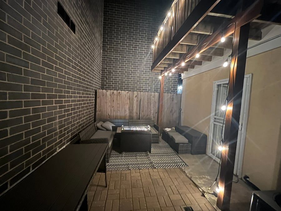 enclosed outdoor patio area with nice lighting.
outdoor includes a grill, firepit and couch with a table. great for small gatherings.