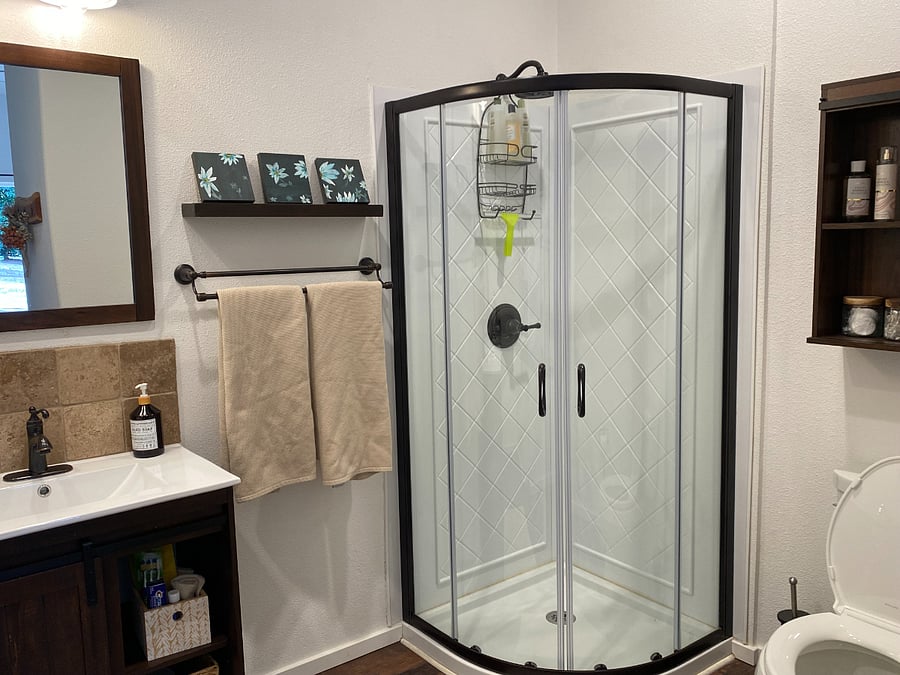 Spacious bathroom with laundry cubby as well.