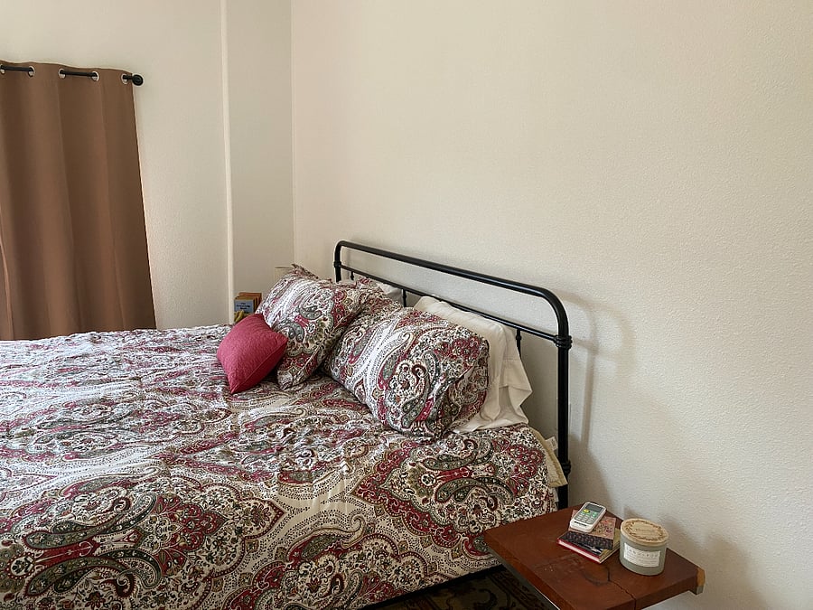 King size bed with side patio and property views.