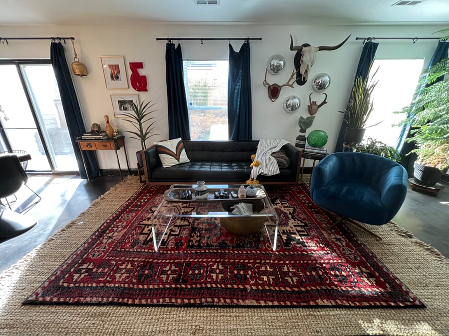 Spacious shared living/dining area with satellite TV, fireplace, exercise equipment, dining table, large windows and views into the backyard.