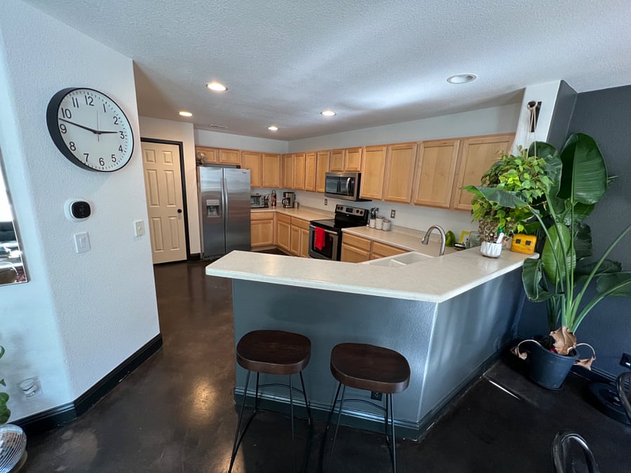 Large shared kitchen with barstools 