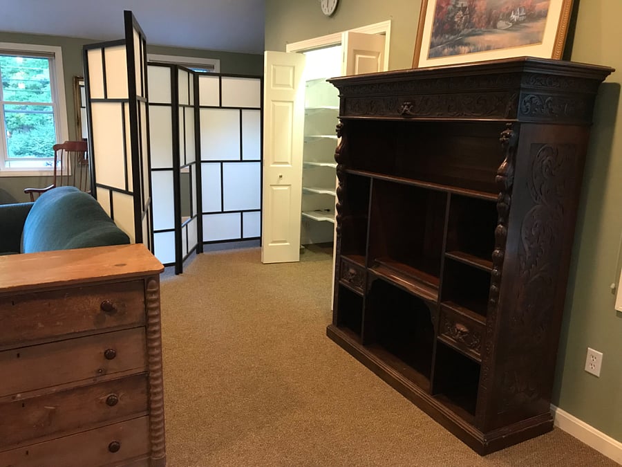 Folding partition creates a private space for changing, and access to closet with multiple shelves