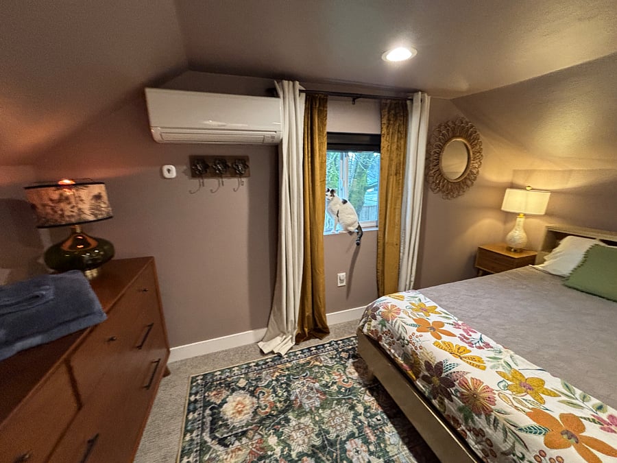 Walking in to the bedroom. Espresso colored blinds and two sets of black out curtains. 