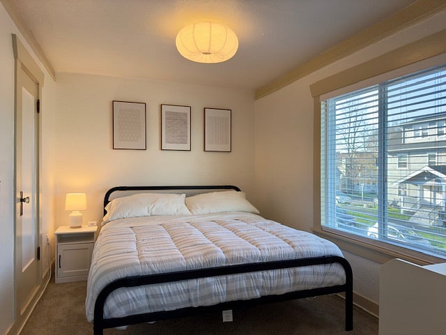 Comfortable California King-sized bed with a new mattress.