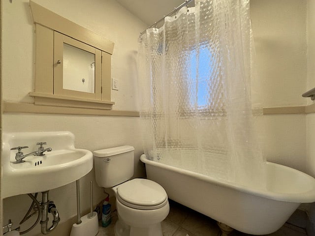 Vintage bathroom with claw-foot tub.