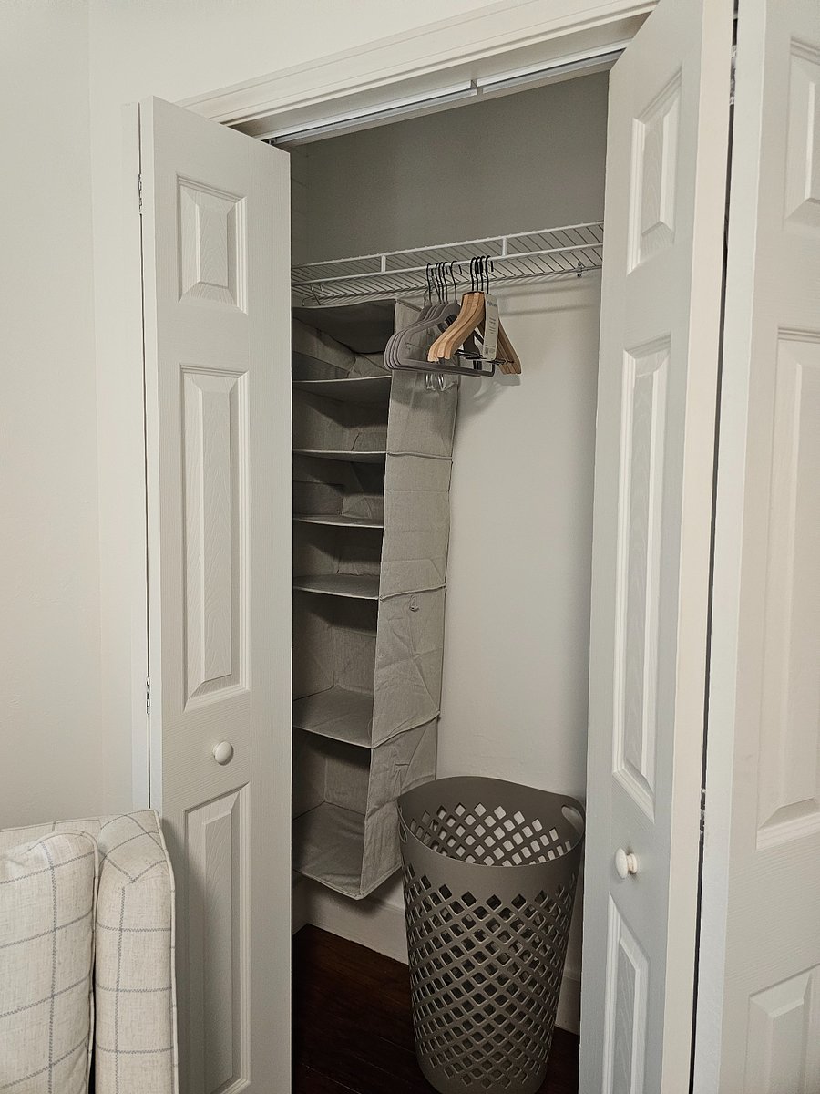 Closets with storage, hangers and laundry baskets