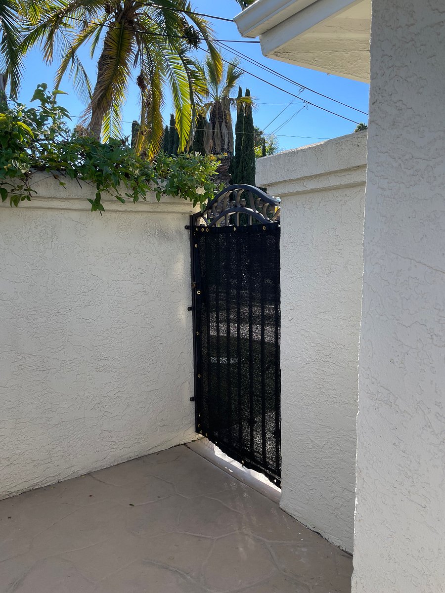 Locked gate entry with privacy screen to keep pets safe.