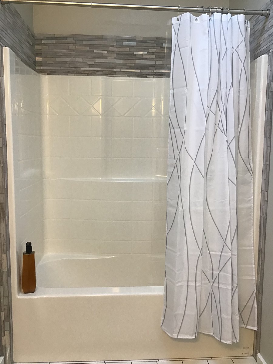 Lower-level bathroom with tub/shower enclosure.