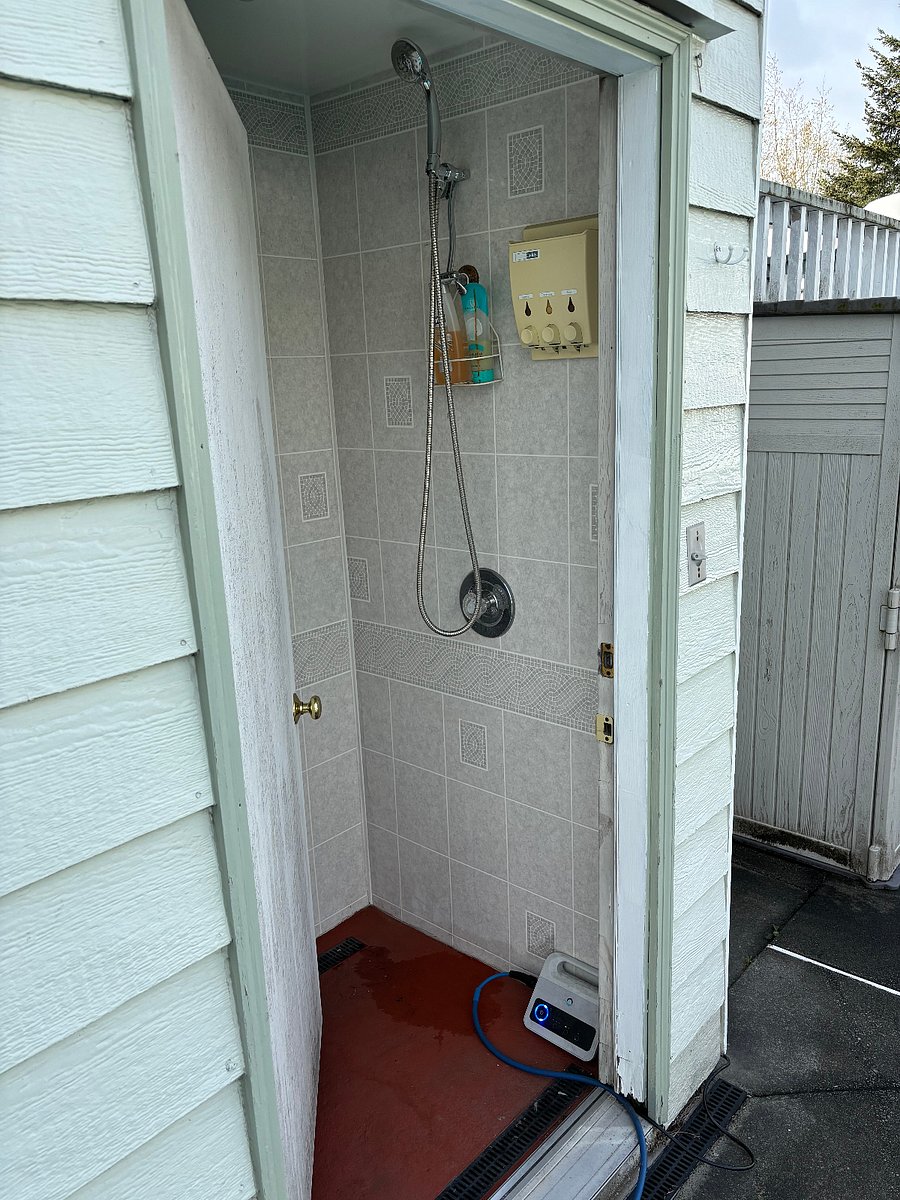 Toilet and shower next to pool