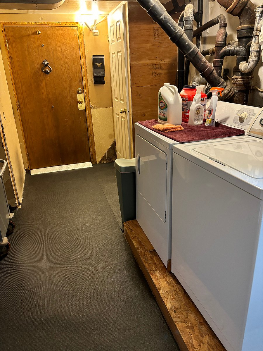Laundry room and entry door to apartment