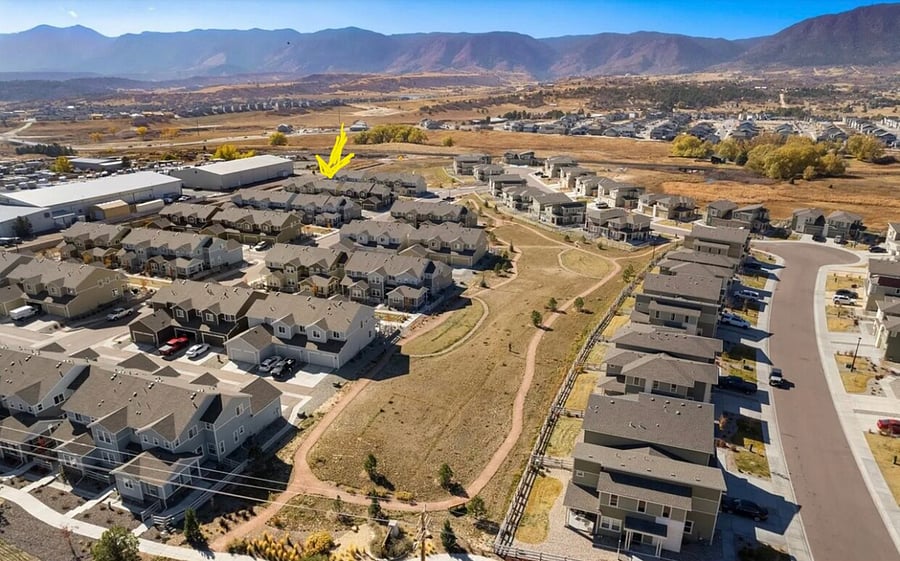 Very new community, Monument ice rink to the left, large silver buildings