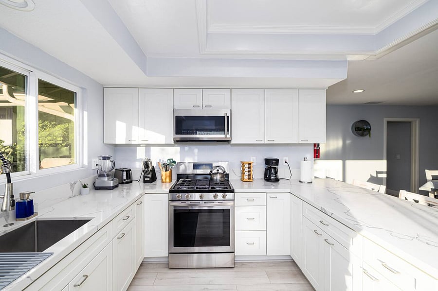 The kitchen is well stocked with cookware, utensils, silverware, and glassware.