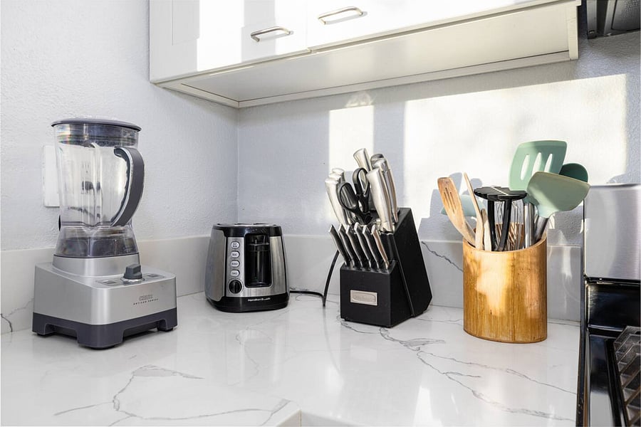 The kitchen is well stocked with cookware, utensils, silverware, and glassware.