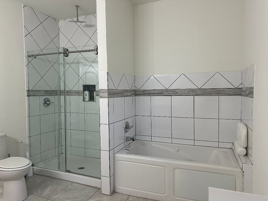 Downstairs shared bathroom with jacuzzi tub.