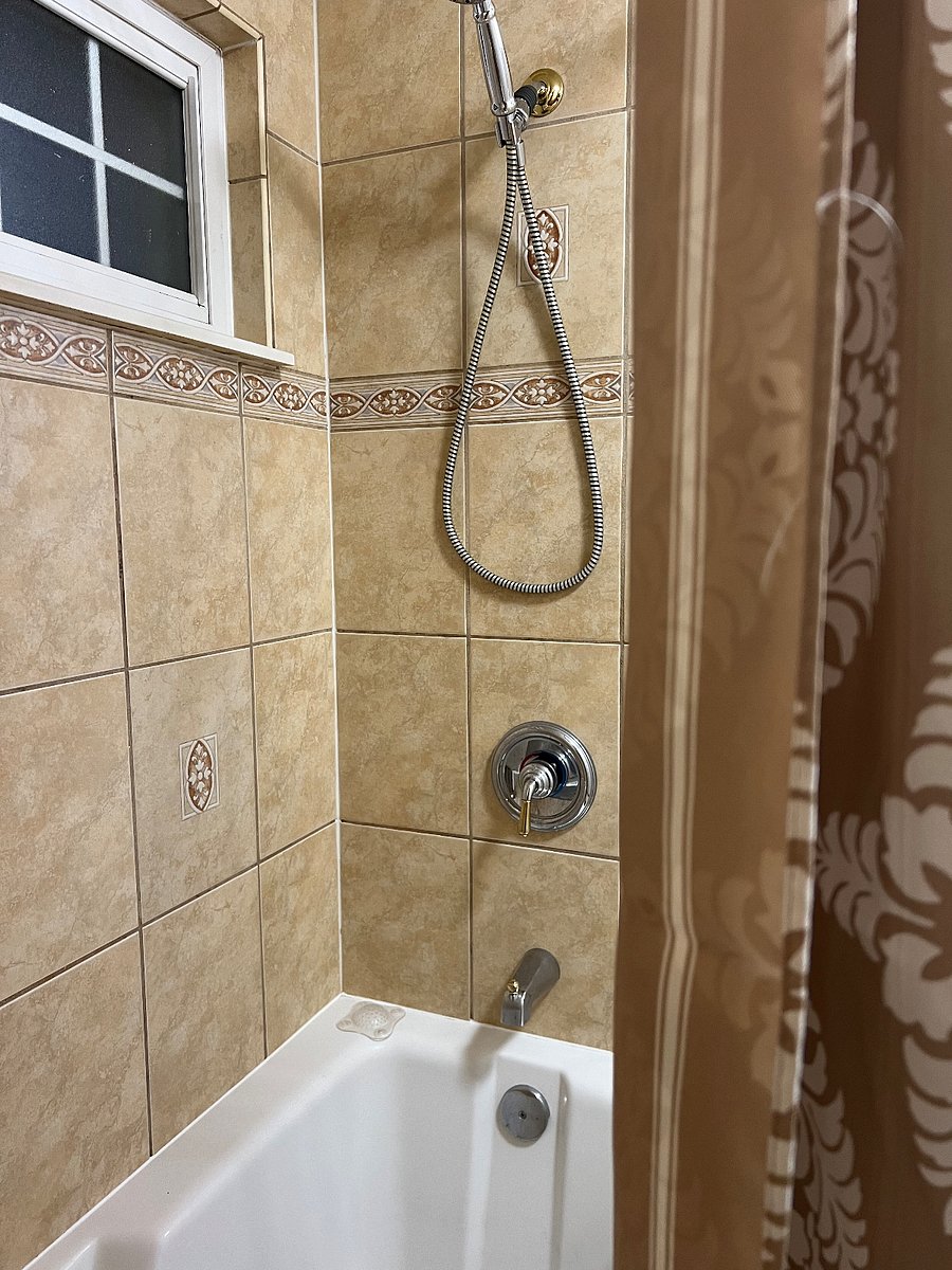 Shared whirlpool bath with shower.